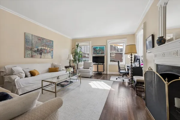 a living room with fireplace furniture and a wooden floor