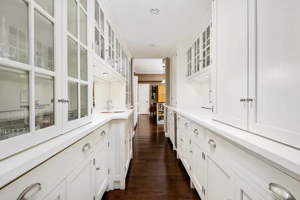 a large white kitchen with a large window