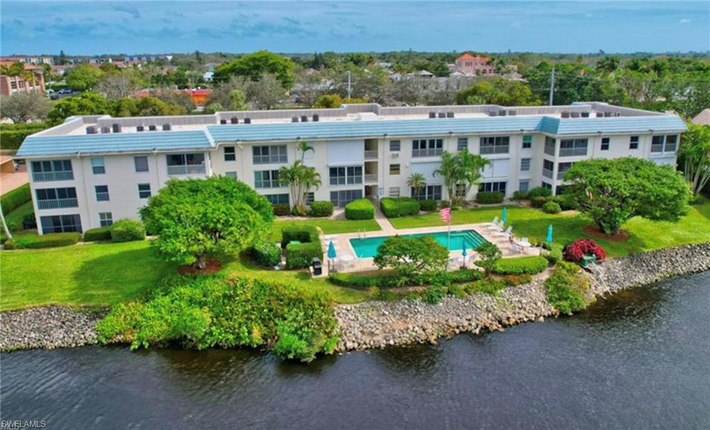 3055 Riviera Drive, Unit 306 Naples, FL 34103 - Photo 25 of 26 Drone / aerial view of a nearby body of water and a pool area