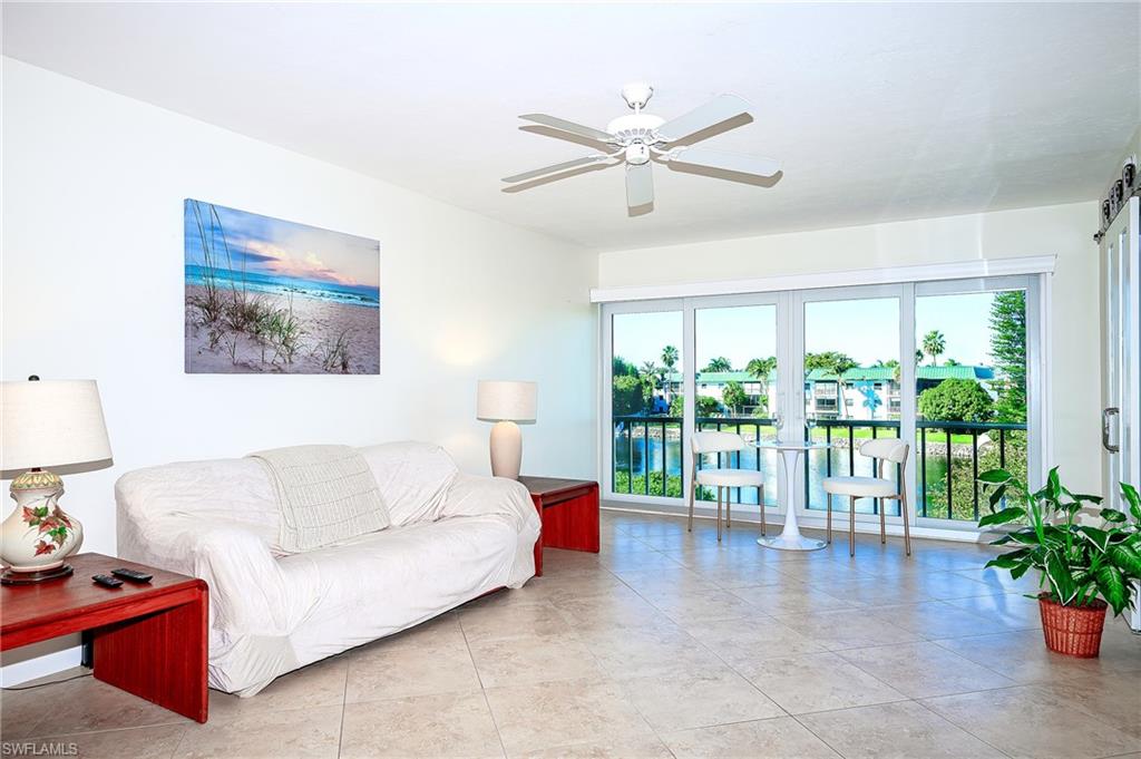 3055 Riviera Drive, Unit 306 Naples, FL 34103 - Photo 5 of 26 Living area featuring plenty of natural light, ceiling fan, and light tile patterned floors