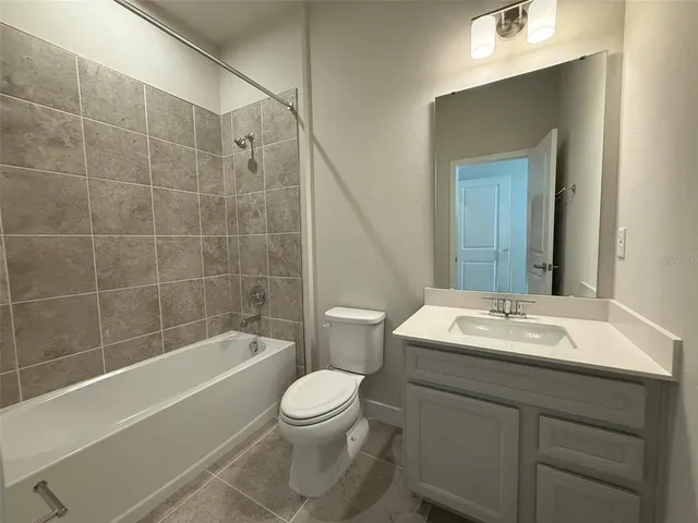 a bathroom with a sink mirror toilet and bathtub