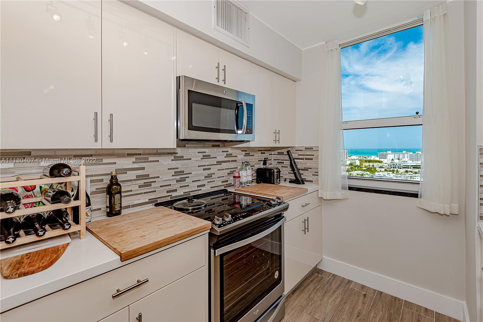 90 Alton Road, Unit 1901 Miami Beach, FL 33139 - Photo 12 of 21 a kitchen with stainless steel appliances granite countertop a stove and a microwave