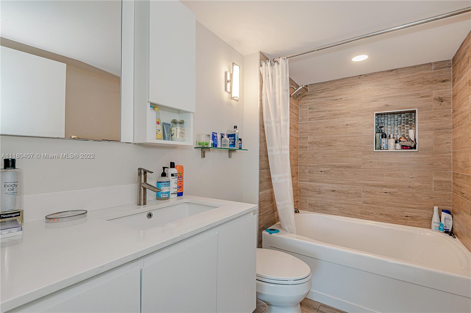 90 Alton Road, Unit 1901 Miami Beach, FL 33139 - Photo 15 of 21 a bathroom with a sink a toilet and a bathtub