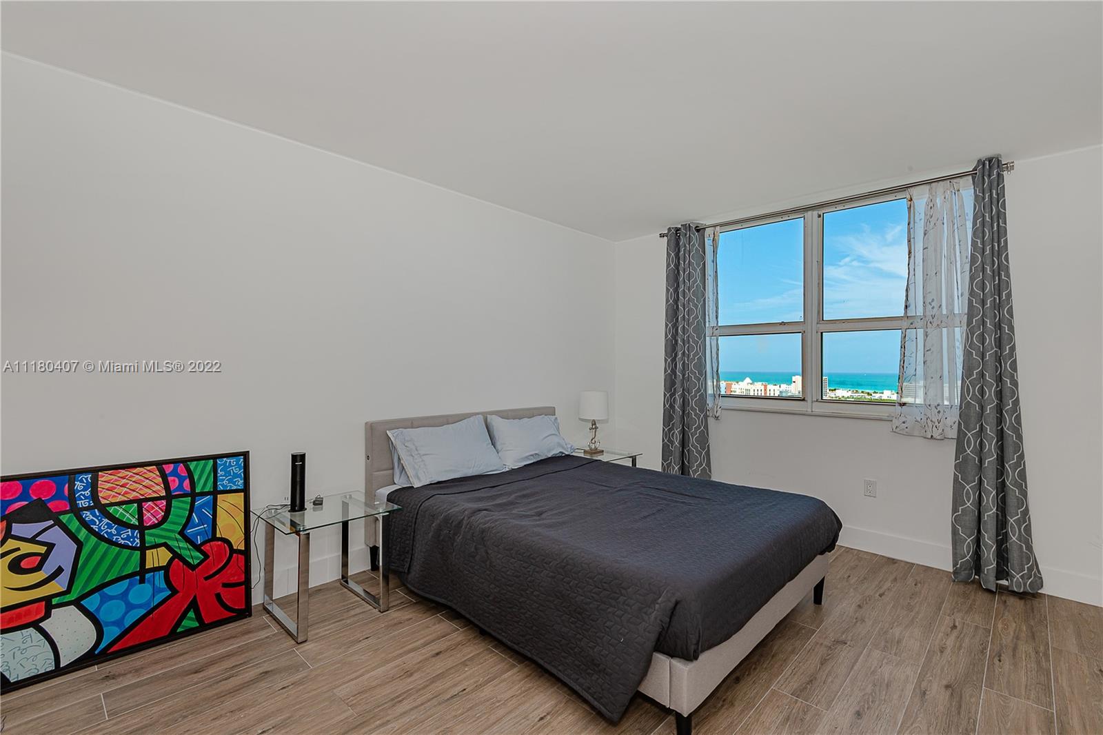 90 Alton Road, Unit 1901 Miami Beach, FL 33139 - Photo 16 of 21 a bedroom with a bed and a window