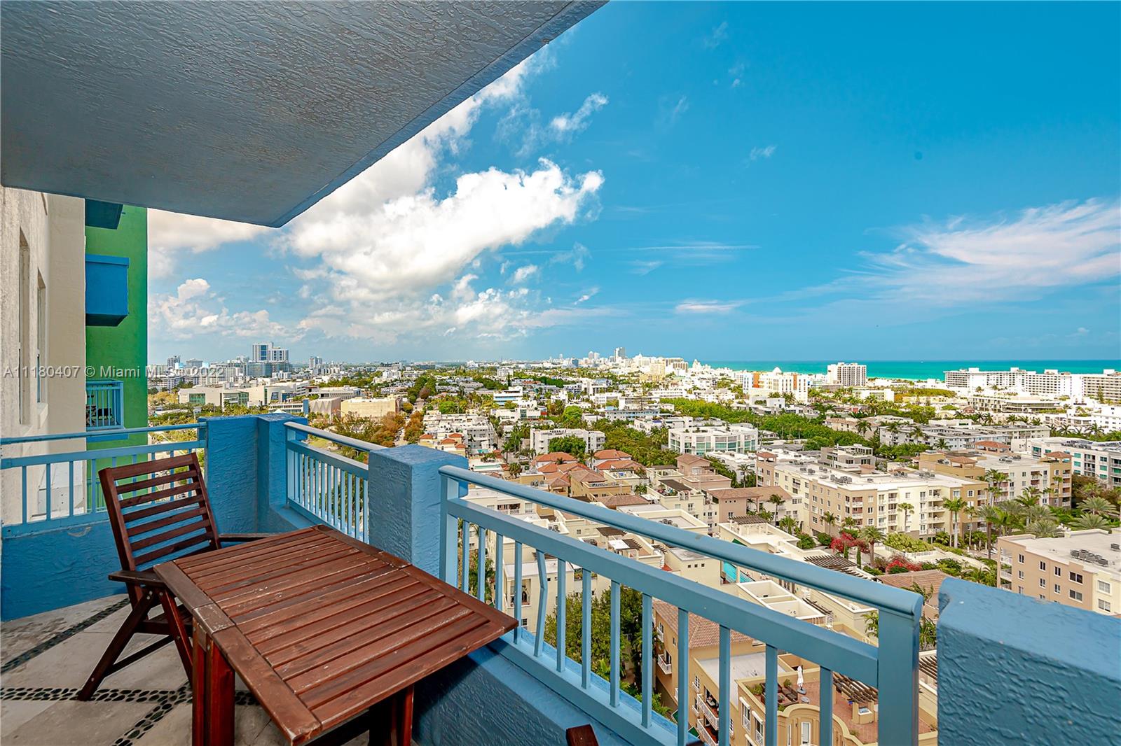 90 Alton Road, Unit 1901 Miami Beach, FL 33139 - Photo 4 of 21 a view of a balcony with wooden benches