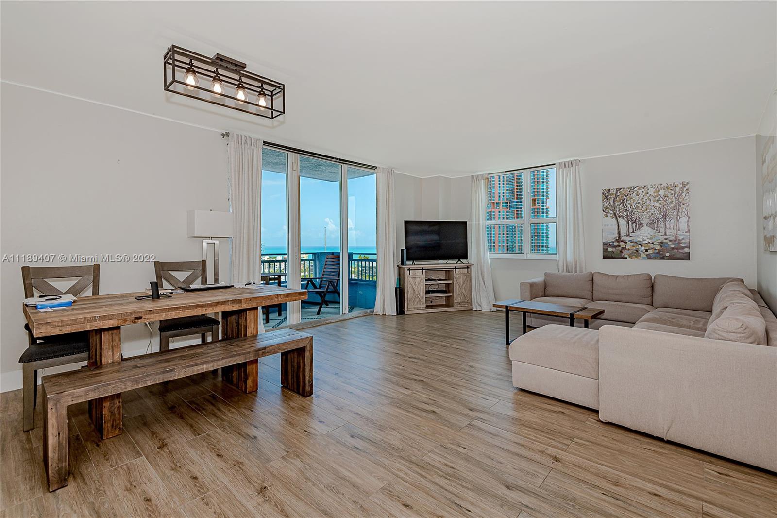 90 Alton Road, Unit 1901 Miami Beach, FL 33139 - Photo 7 of 21 a living room with furniture and a flat screen tv