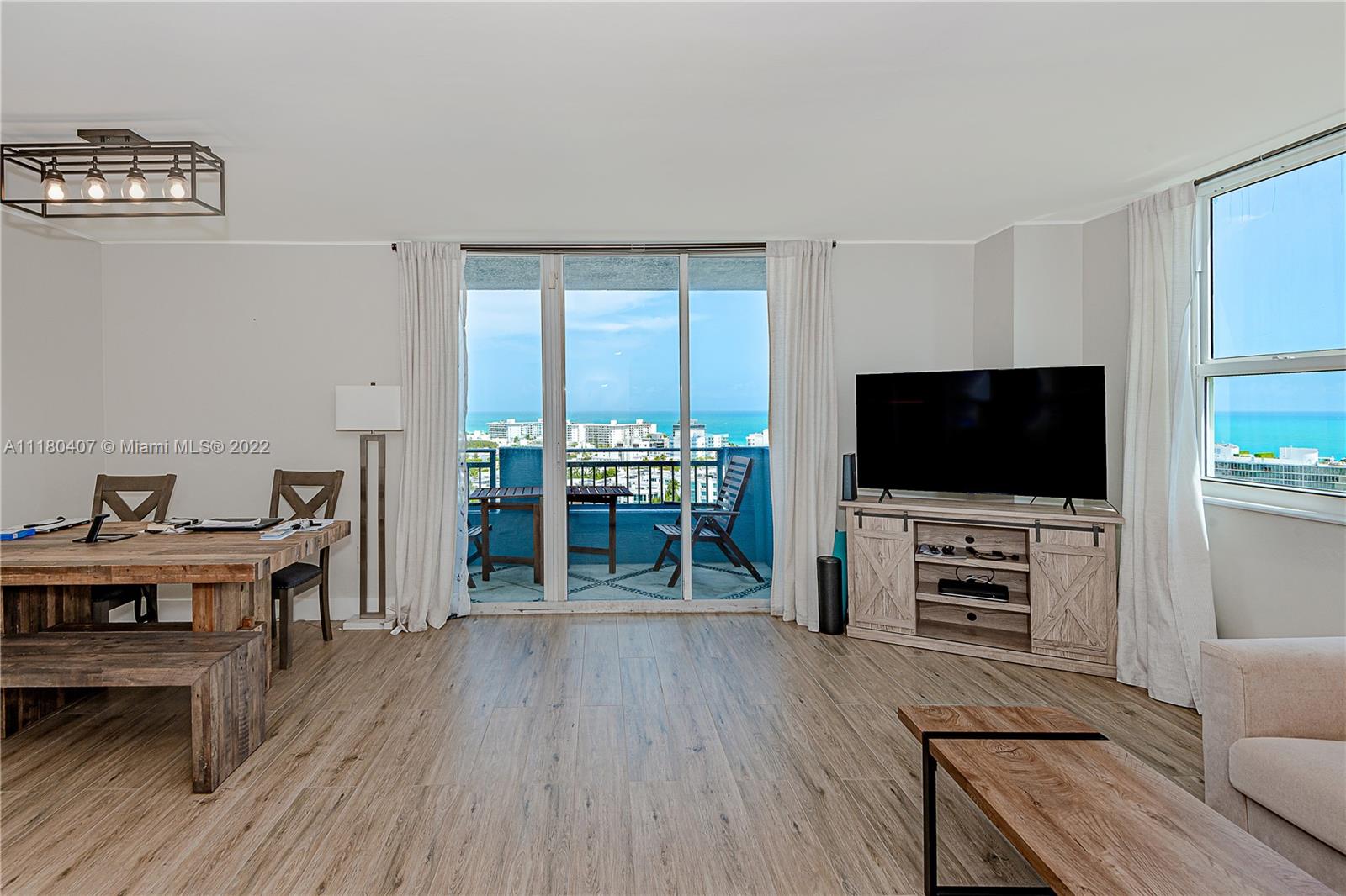 90 Alton Road, Unit 1901 Miami Beach, FL 33139 - Photo 8 of 21 a view of a livingroom with furniture and wooden floor