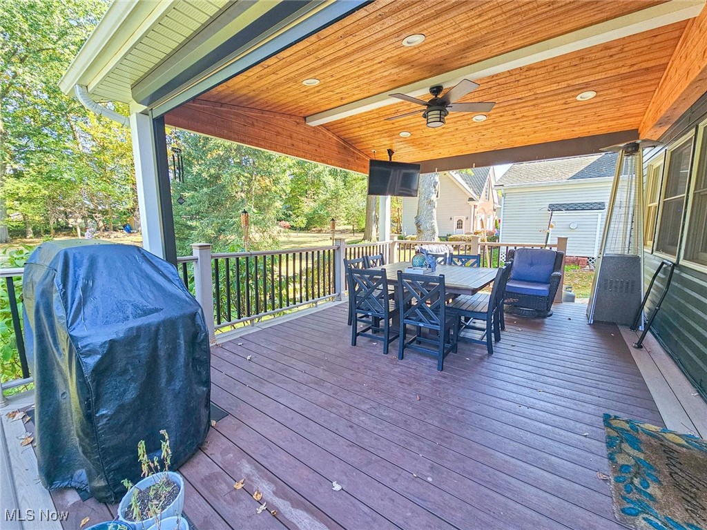 4270 Mellinger Road Canfield, OH 44406 - Photo 39 of 49 Wooden deck with grilling area, a ceiling fan, and outdoor dining space