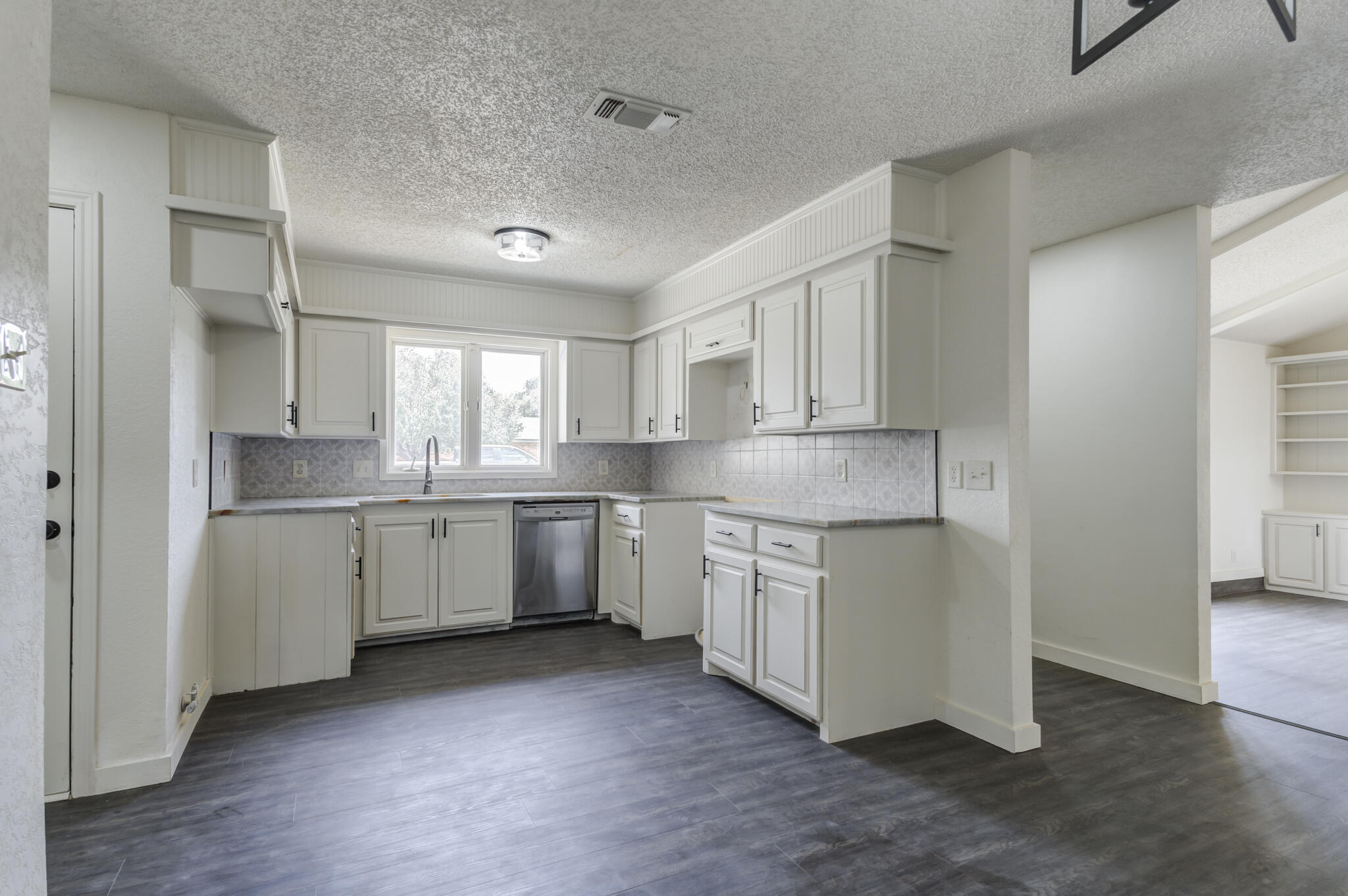 3006 93rd Street Lubbock, TX 79423 - Photo 17 of 35 a kitchen with granite countertop white cabinets and white appliances