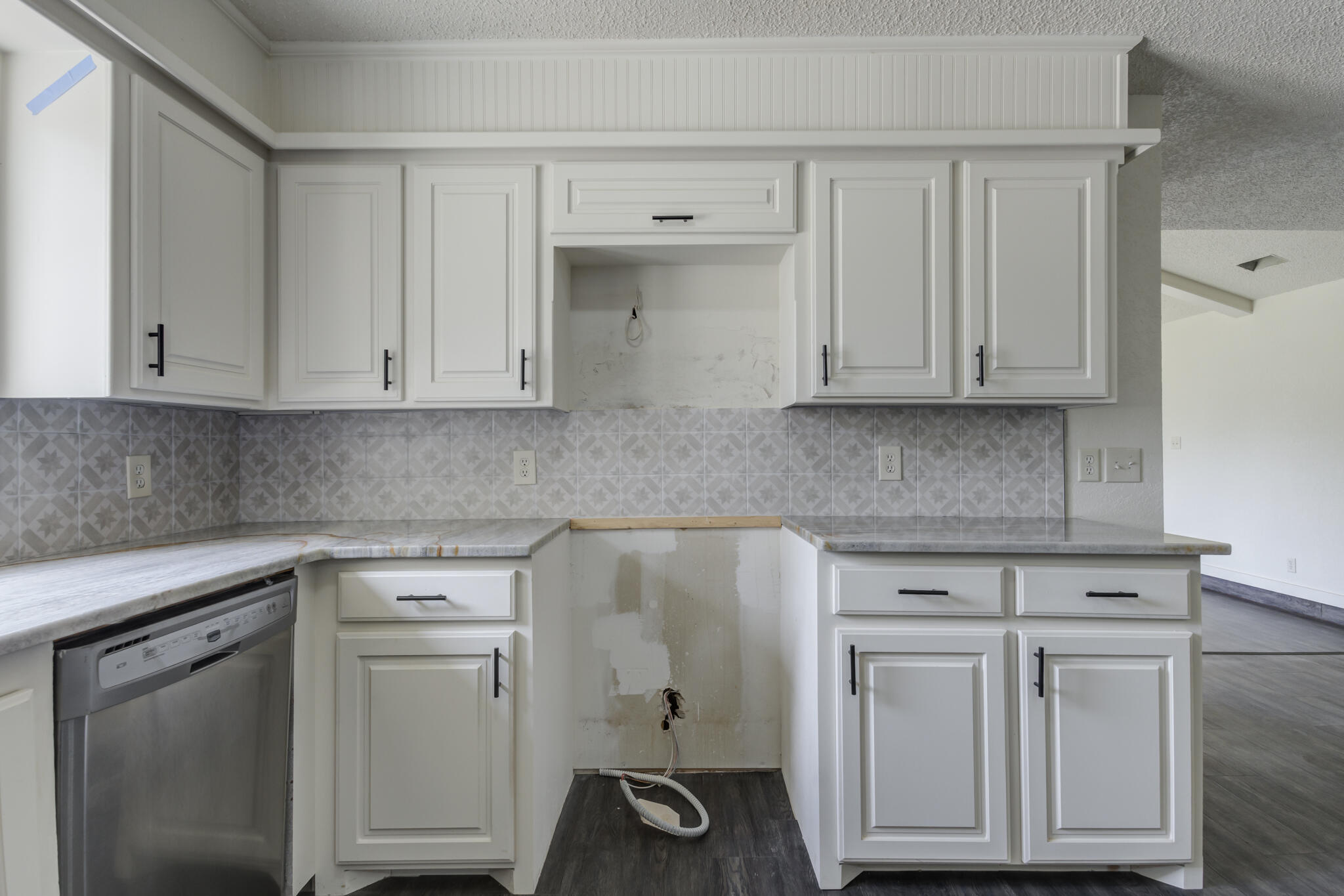 3006 93rd Street Lubbock, TX 79423 - Photo 19 of 35 a kitchen with white cabinets and white appliances
