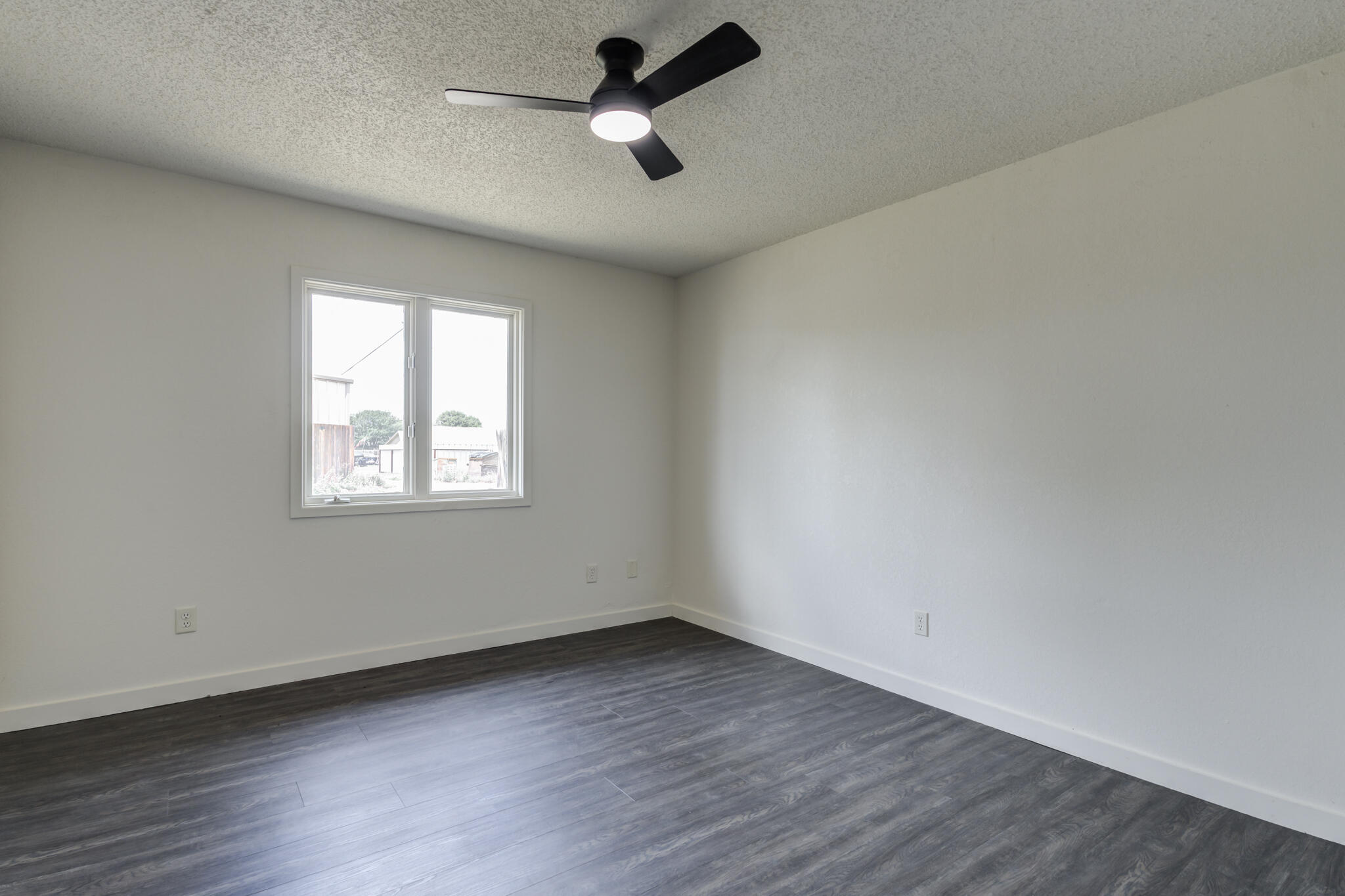 3006 93rd Street Lubbock, TX 79423 - Photo 25 of 35 an empty room with a window and a ceiling fan