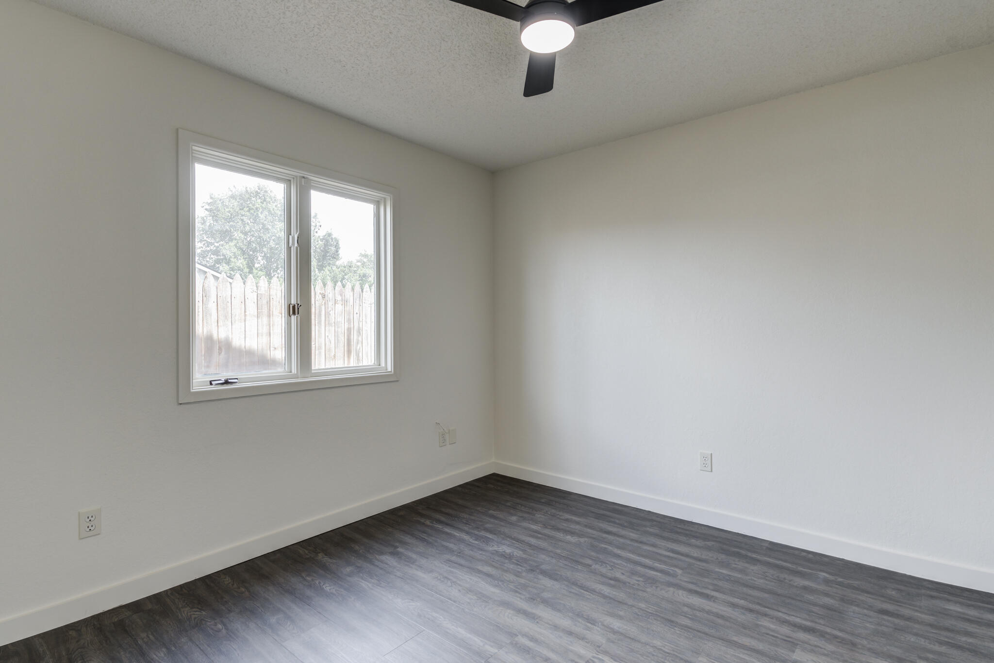 3006 93rd Street Lubbock, TX 79423 - Photo 27 of 35 an empty room with wooden floor and windows
