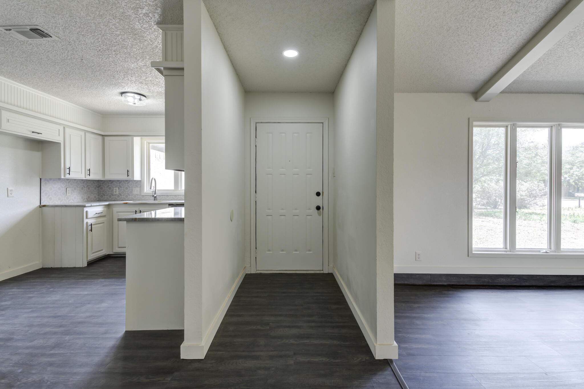3006 93rd Street Lubbock, TX 79423 - Photo 3 of 35 a view of a kitchen with wooden floor and a window