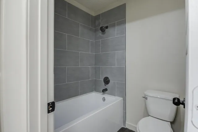 a bathroom with a toilet and bathtub
