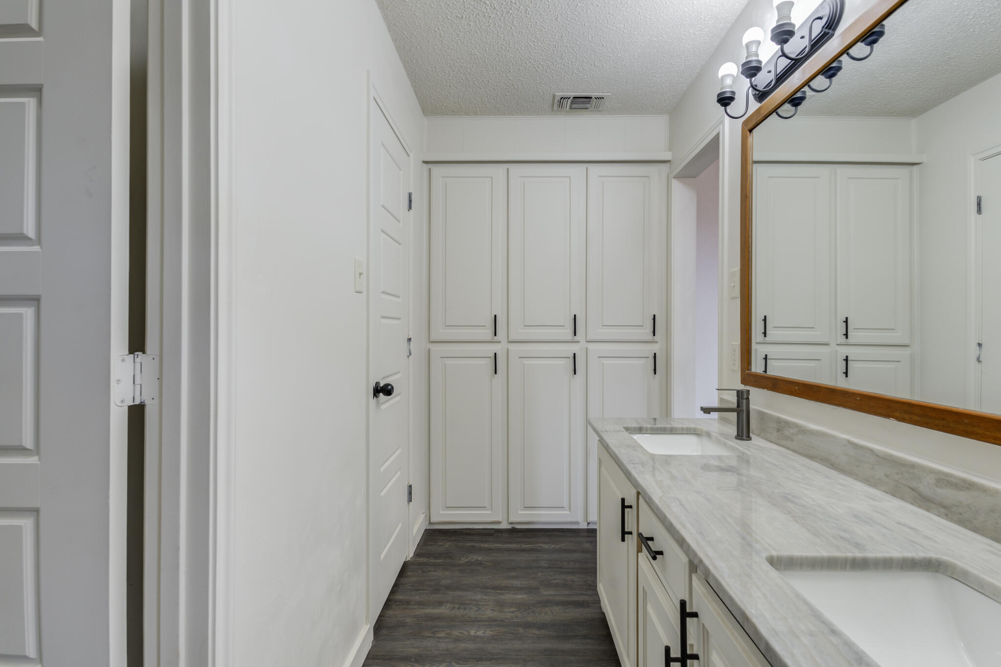 3006 93rd Street Lubbock, TX 79423 - Photo 34 of 35 a bathroom with a granite countertop sink and a mirror