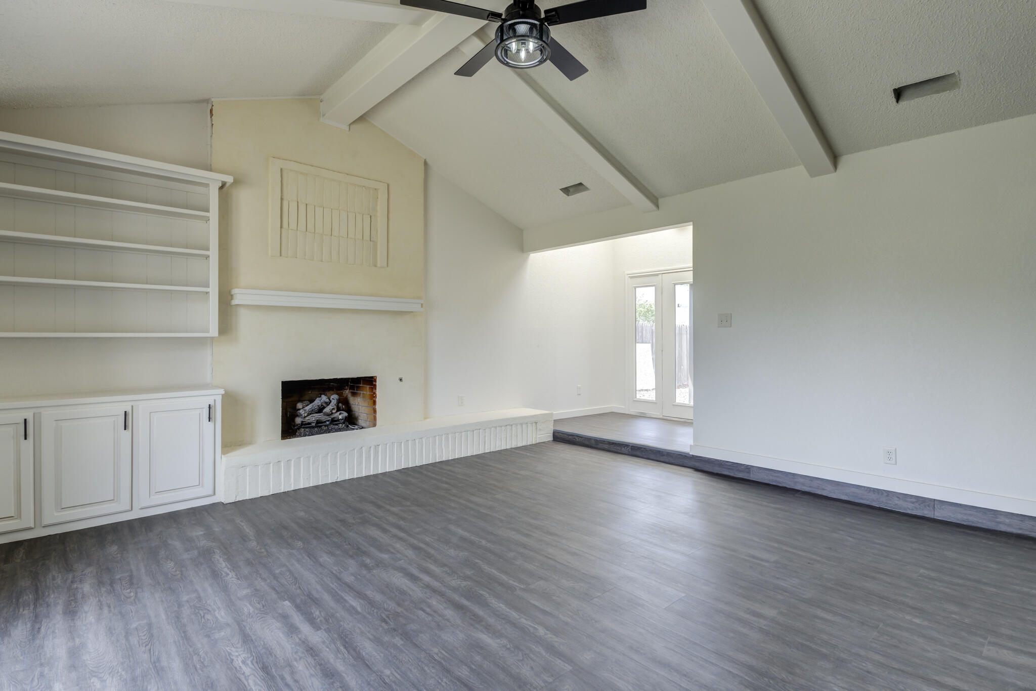 3006 93rd Street Lubbock, TX 79423 - Photo 7 of 35 a view of an empty room with a window and fireplace