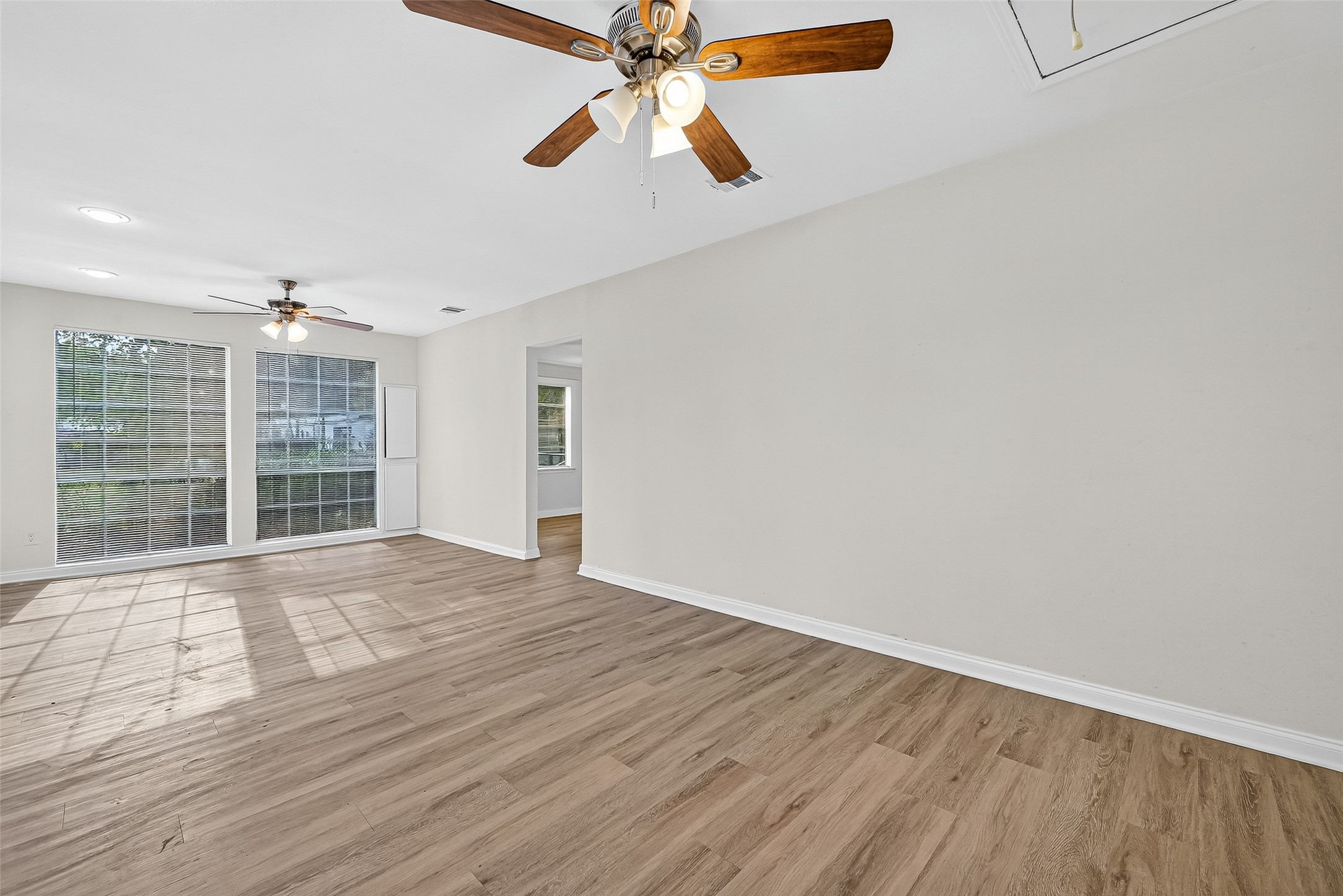 16643 Lake Circle Conroe, TX 77302 - Photo 13 of 47 a view of an empty room with a window and wooden floor