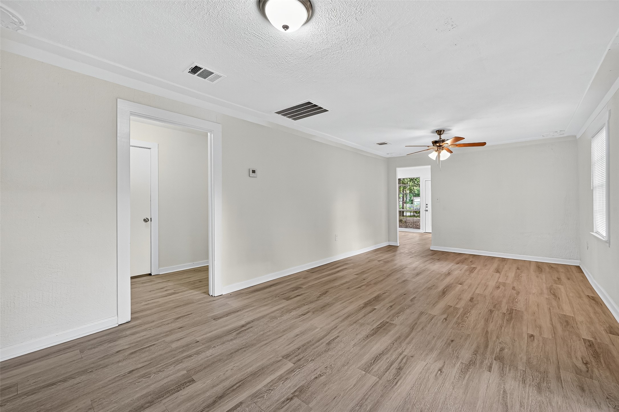 16643 Lake Circle Conroe, TX 77302 - Photo 18 of 47 wooden floor in an empty room with a window