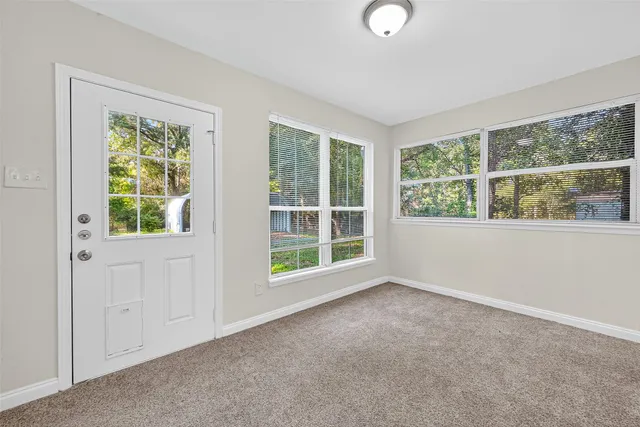 a view of an empty room with closet area