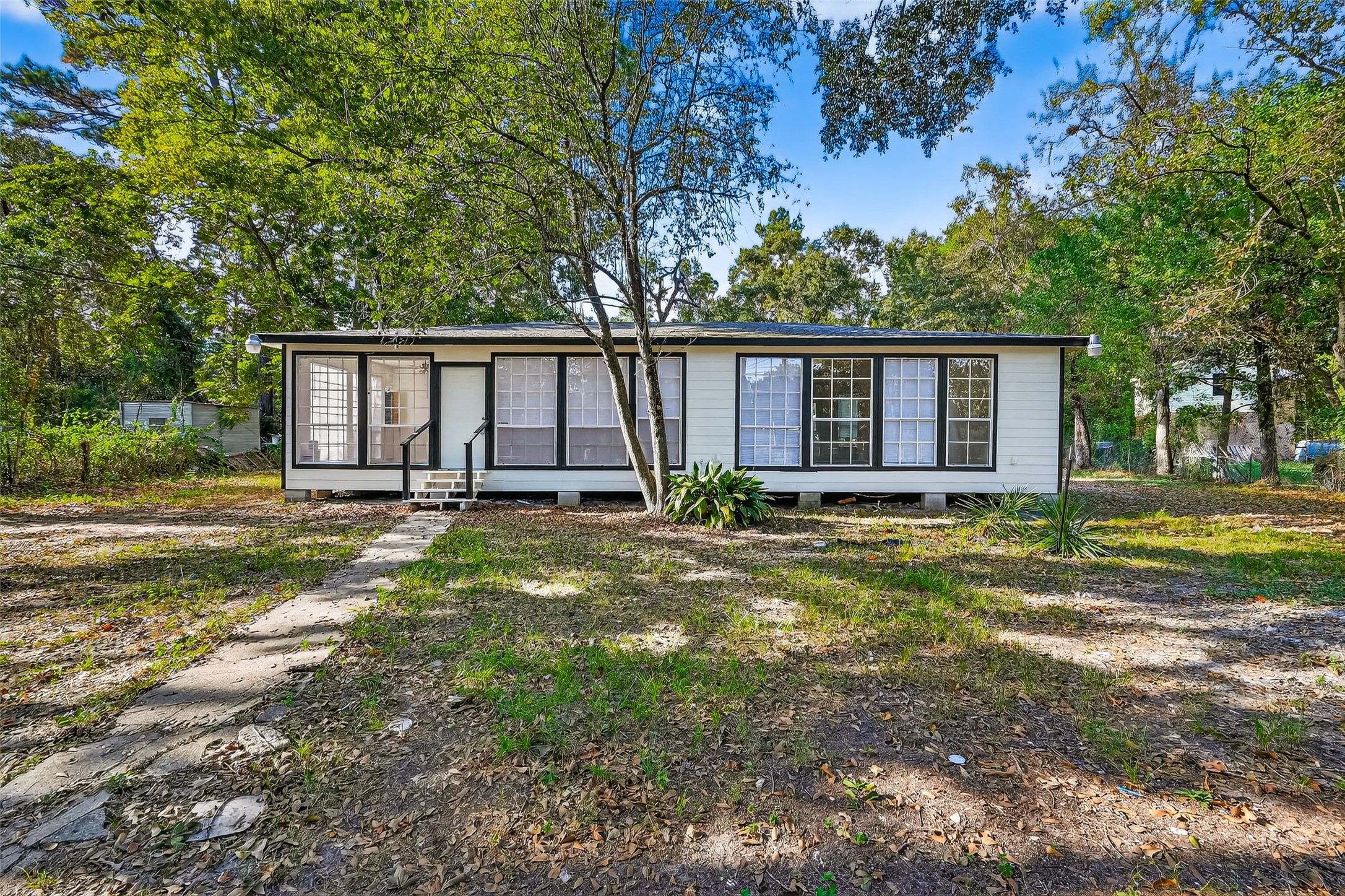 16643 Lake Circle Conroe, TX 77302 - Photo 5 of 47 a view of a house with backyard and trees