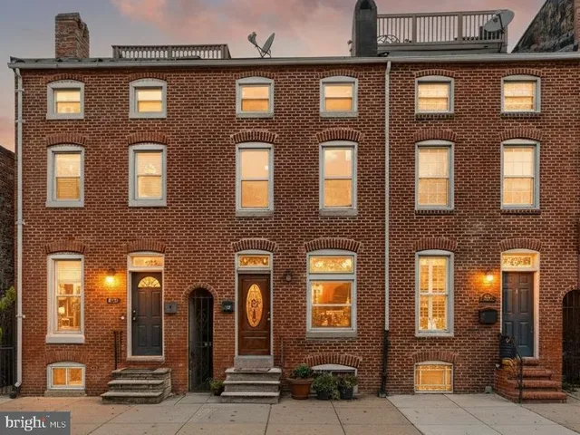 a front view of a brick building with many windows