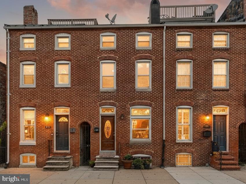 a front view of a brick building with many windows