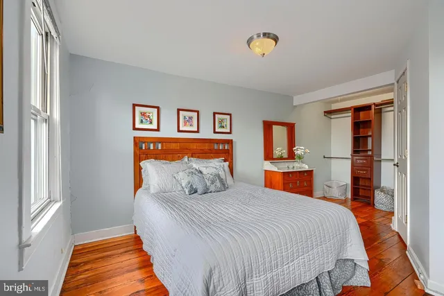 a bedroom with bed and table