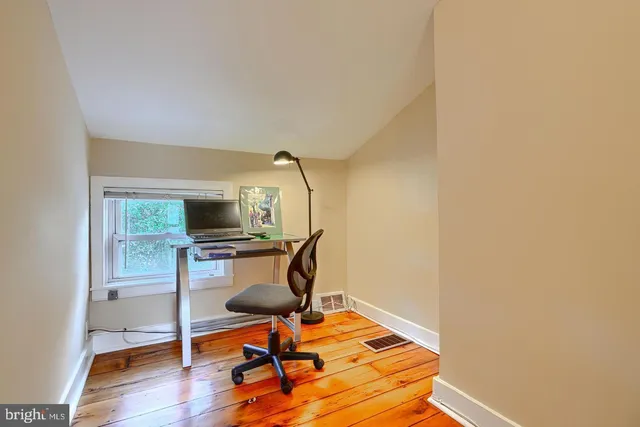a workspace with furniture and wooden floor