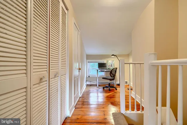 a view of a hallway with a livingroom with furniture