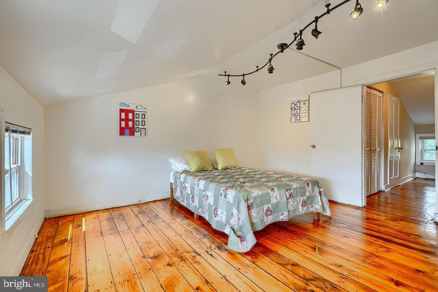 1806 Bank Street Baltimore, MD 21231 - Photo 18 of 21 a bedroom with a bed and a wooden floor