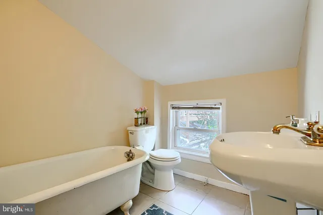 a bathroom with a sink a toilet and a bathtub
