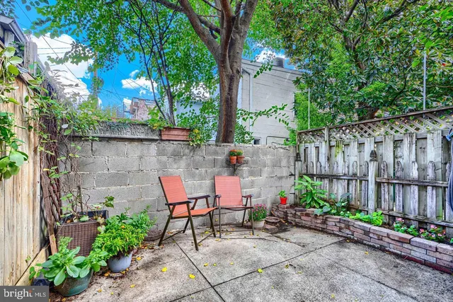 a view of a chairs and table in backyard