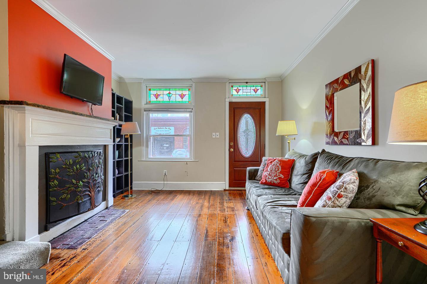 1806 Bank Street Baltimore, MD 21231 - Photo 3 of 21 a living room with furniture and a fireplace