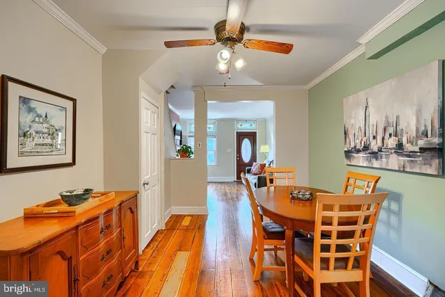 a dining room with furniture and wooden floor