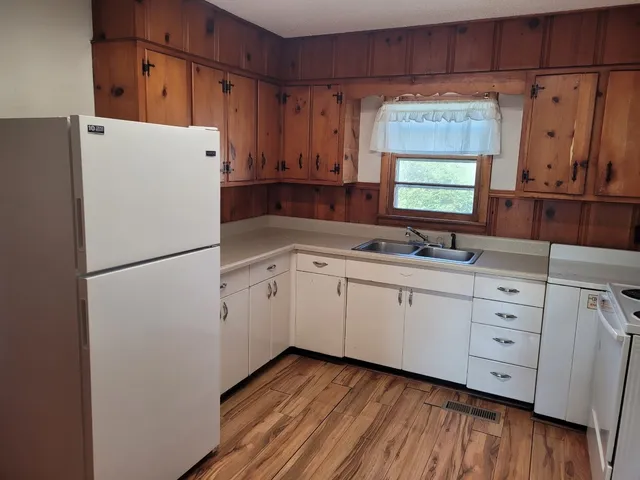 a kitchen with appliances a sink and cabinets