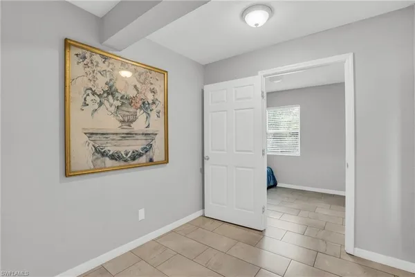 an empty room with windows and closet
