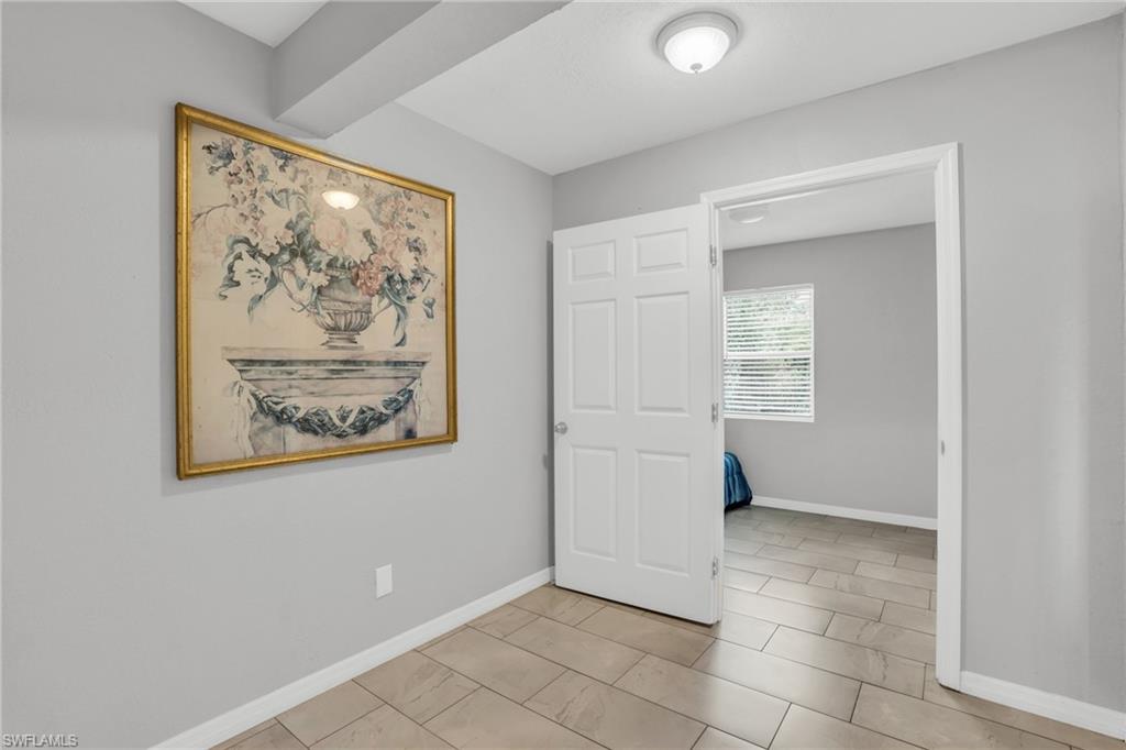 883 Coconut Circle East Naples, FL 34104 - Photo 12 of 32 an empty room with windows and closet