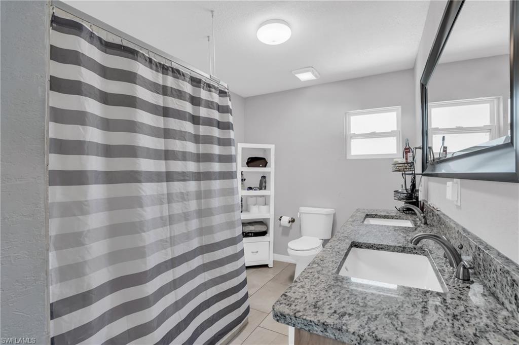 883 Coconut Circle East Naples, FL 34104 - Photo 17 of 32 a bathroom with a sink toilet and shower