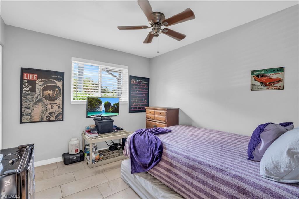 883 Coconut Circle East Naples, FL 34104 - Photo 24 of 32 a bedroom with furniture or couch and a window