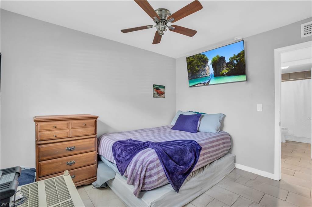 883 Coconut Circle East Naples, FL 34104 - Photo 25 of 32 a bedroom with a bed and a dresser