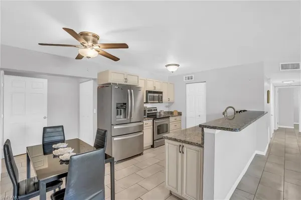 a kitchen with refrigerator cabinets and furniture