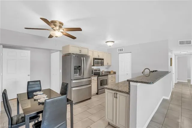 a kitchen with refrigerator cabinets and furniture