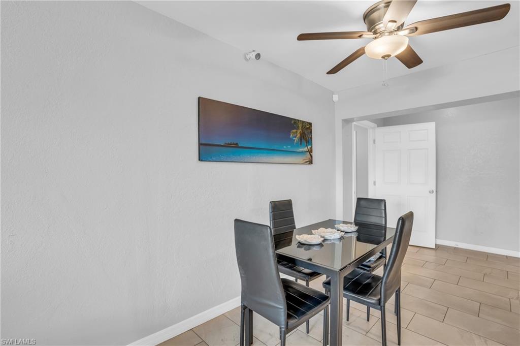883 Coconut Circle East Naples, FL 34104 - Photo 10 of 32 a view of a dining room with furniture
