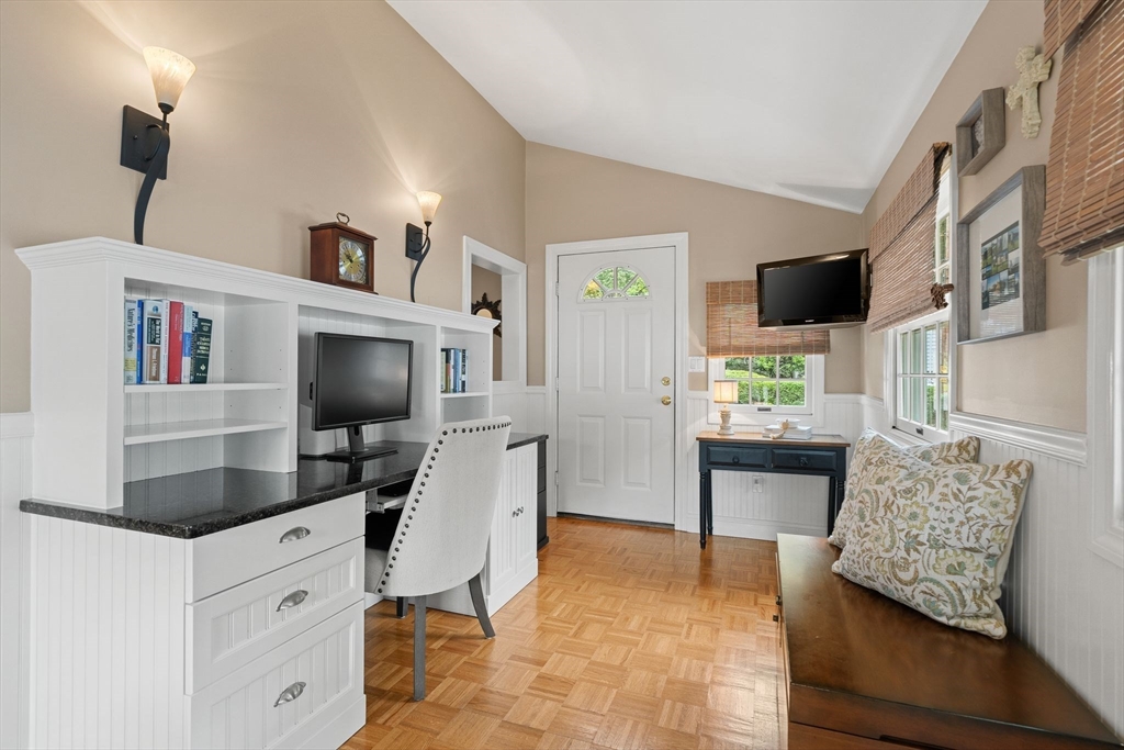 4 Joyce Road Arlington, MA 02474 - Photo 15 of 42 a workspace with furniture and a flat screen tv