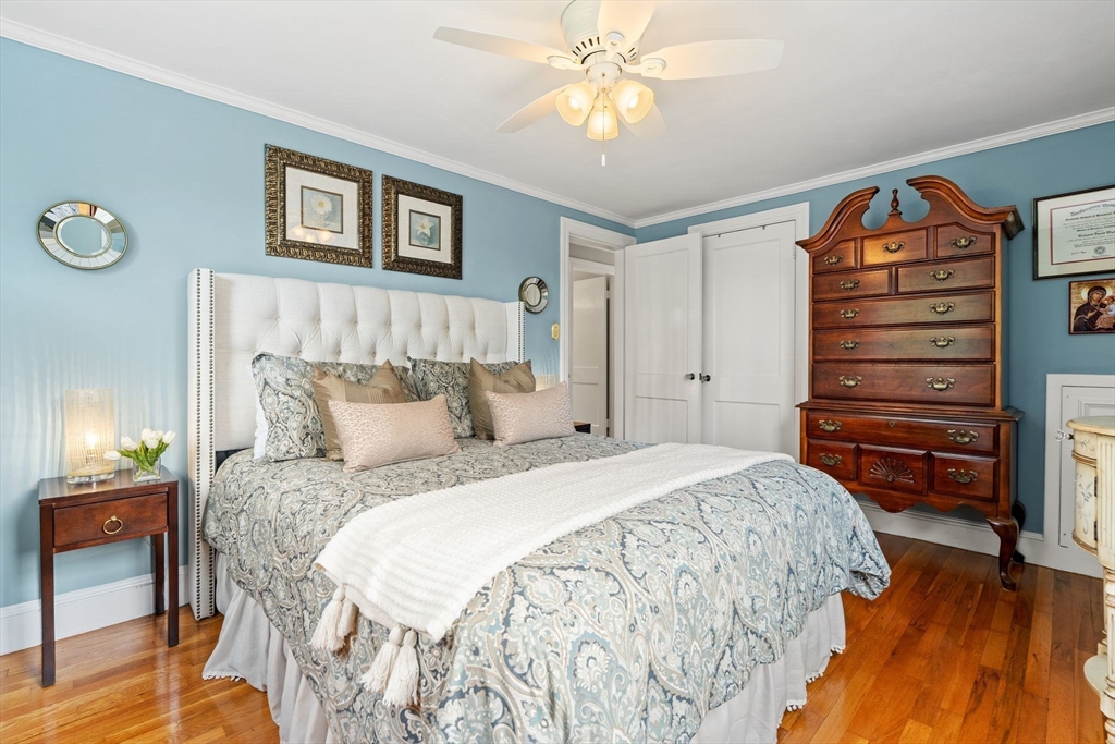 4 Joyce Road Arlington, MA 02474 - Photo 26 of 42 a bedroom with a bed and a chandelier