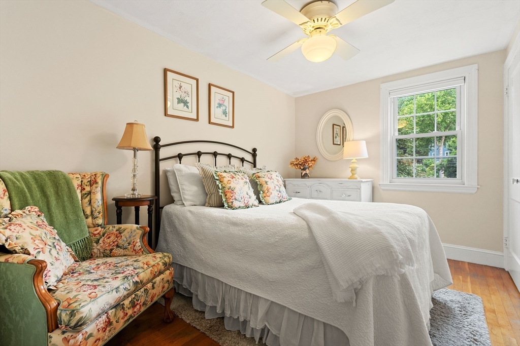 4 Joyce Road Arlington, MA 02474 - Photo 27 of 42 a bedroom with a bed and a chandelier