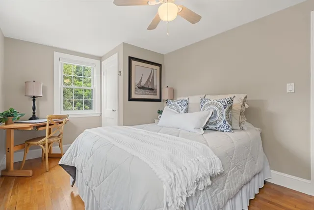 a bedroom with a large bed and a desk