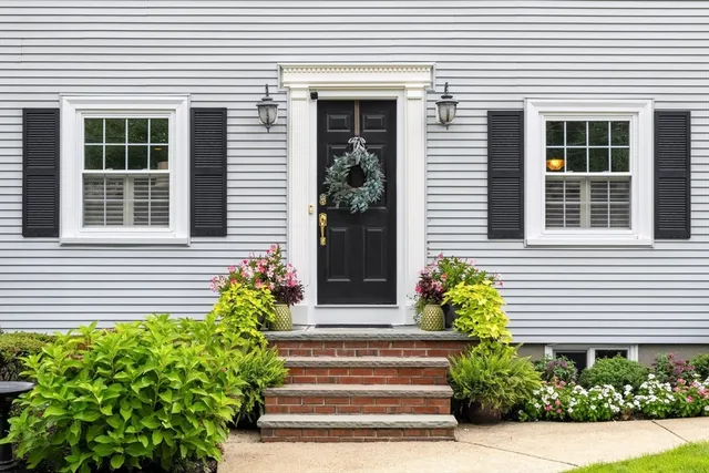 a front view of a house with potted plants