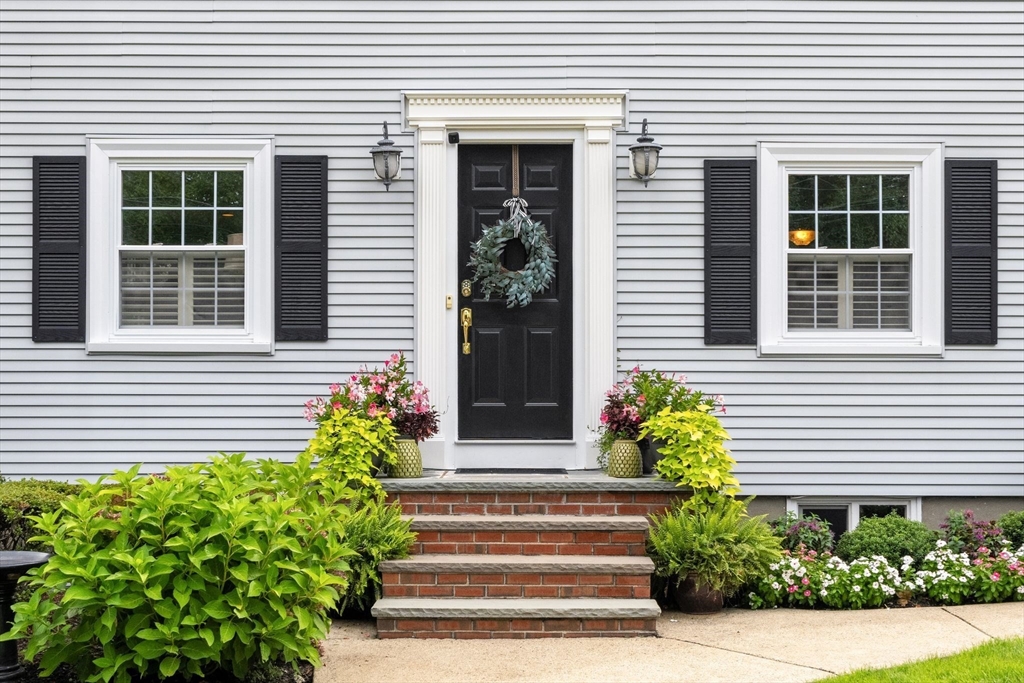4 Joyce Road Arlington, MA 02474 - Photo 3 of 42 a front view of a house with potted plants