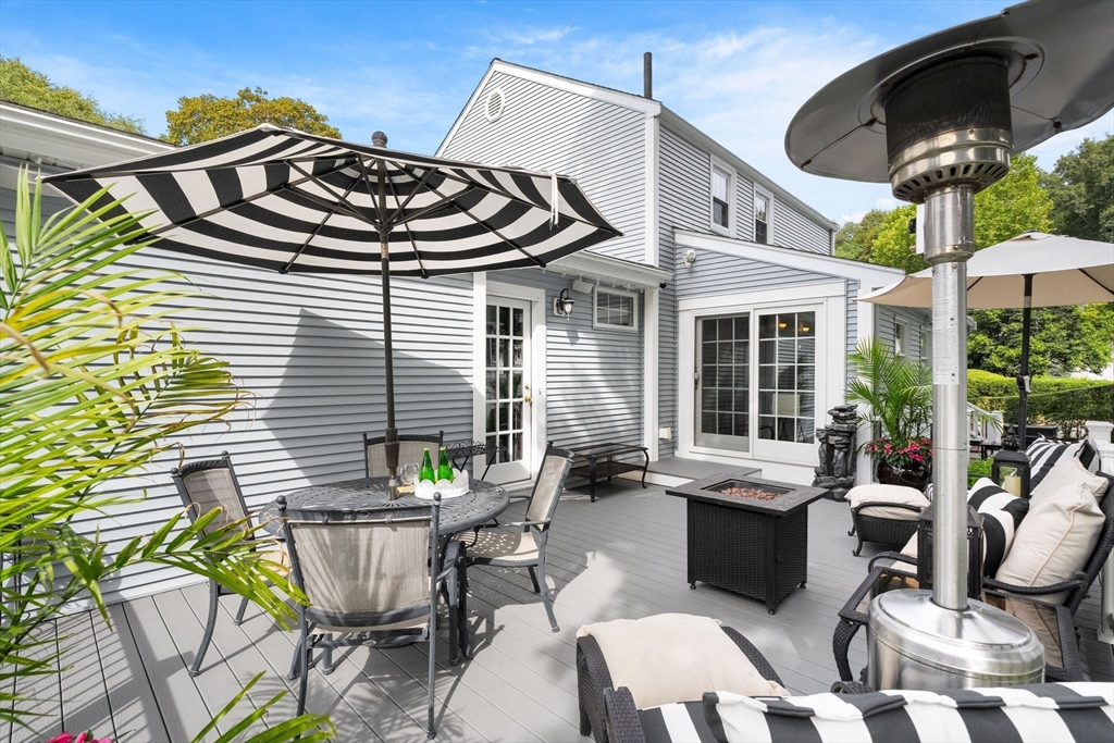 4 Joyce Road Arlington, MA 02474 - Photo 32 of 42 a view of a patio with table and chairs and potted plants
